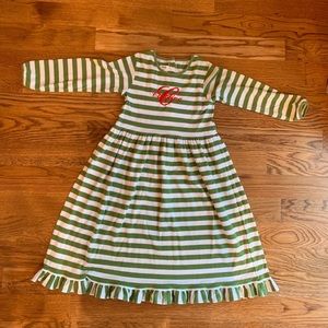 Green and white striped dress with “C/Caroline” monogram